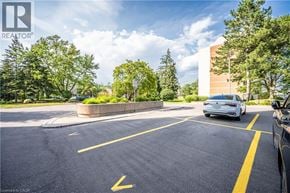 Waterloo condo for rent - A parking lot with a white car parked in the first spot.