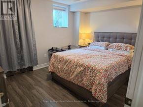 Milton (Fo Ford) apartment for rent - A bedroom with a bed covered in a floral print bedspread.