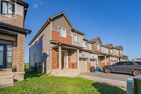 Ottawa townhouse for rent - A row of townhouses with a car parked in front of the first one.