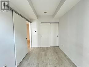 Toronto (Church-Yonge Corridor) condo for rent - A room with white walls and wood flooring, with a sliding door in the middle.