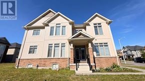 Collingwood apartment for rent - A two-story house with a brick base and a beige upper section.