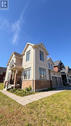 Collingwood apartment for rent - A large, two-story house with a balcony and a small garden in front.