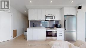 Toronto (Weston-Pellam Park) condo for rent - A modern kitchen with stainless steel appliances and white cabinetry.
