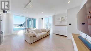 Toronto (Weston-Pellam Park) condo for rent - A spacious living room with a large window and a white sofa.