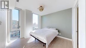 Toronto (Weston-Pellam Park) condo for rent - A bedroom with a large bed and a window overlooking a cityscape.
