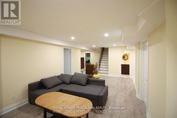 Oakville (Ga Glen Abbey) apartment for rent - A living room with a couch and a coffee table.