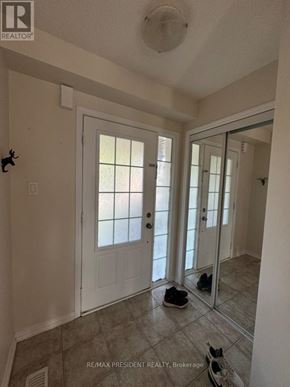 Brantford townhouse for rent - A room with a white door and a pair of shoes on the floor.
