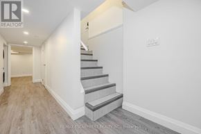 Hamilton (Beasley) multi-family for rent - A hallway with a staircase and a door on the left.