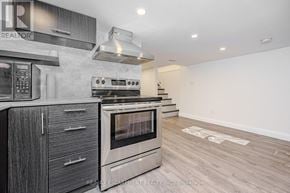 Hamilton (Beasley) multi-family for rent - A modern kitchen with a stainless steel oven and wooden cabinets.