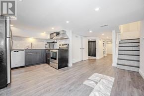 Hamilton (Beasley) multi-family for rent - A spacious kitchen with a refrigerator, oven, and stove.