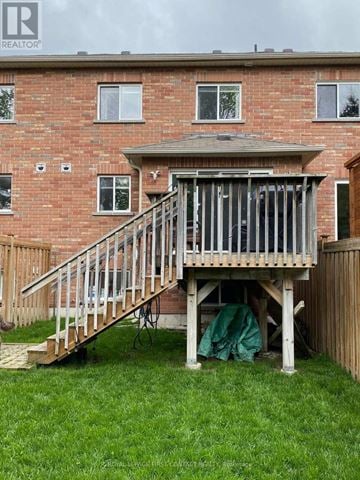 Barrie (Georgian Drive) townhouse for rent - A wooden deck under construction in front of a brick house.
