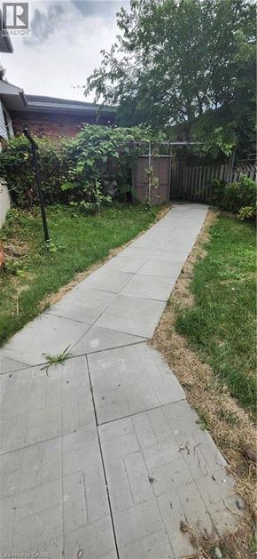 Kitchener apartment for rent - A concrete pathway leads through a grassy area.