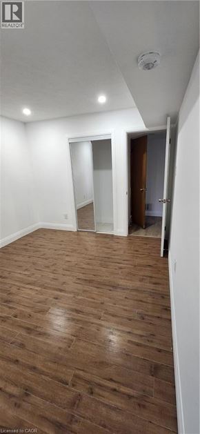 Kitchener apartment for rent - A room with wooden flooring and a white ceiling.