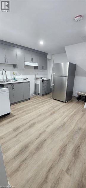 Kitchener apartment for rent - A kitchen with wooden flooring and stainless steel appliances.
