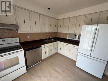 Toronto (Agincourt North) townhouse for rent - A kitchen with white cabinets and a white refrigerator.
