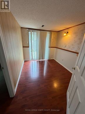 Toronto (Agincourt North) townhouse for rent - A room with wooden floors and white walls.