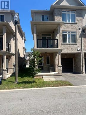 Hamilton (Winona Park) townhouse for rent - A large house with a balcony is situated in front of a smaller house.