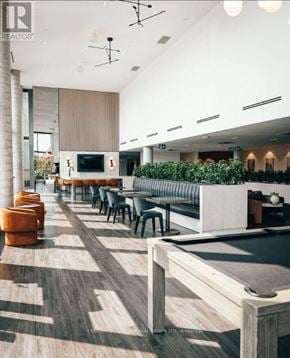 Kitchener house for rent - A modern interior with a pool table and a bar area.