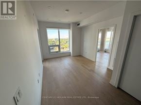 Kitchener house for rent - A spacious room with wooden flooring and large windows overlooking a view.