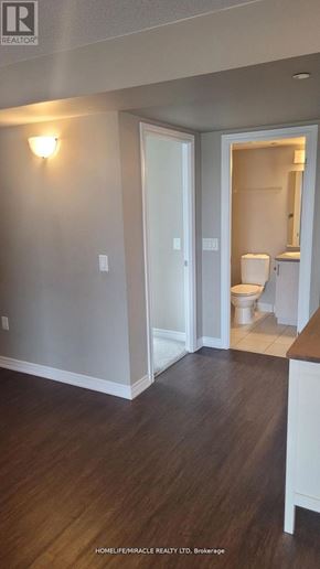 Milton (Tm Timberlea) condo for rent - A bathroom with a toilet and sink visible through the door.