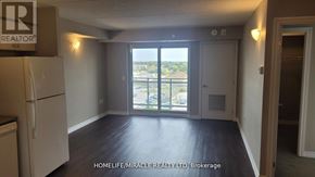 Milton (Tm Timberlea) condo for rent - A room with a refrigerator and a view of the outside.