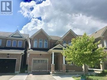 Markham (Box Grove) apartment for rent - A house with a large front yard and a tree in front of it.