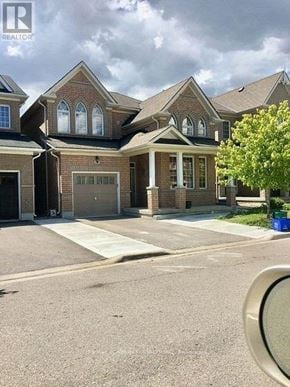 Markham (Box Grove) apartment for rent - A large house with a brick facade and a large front yard.