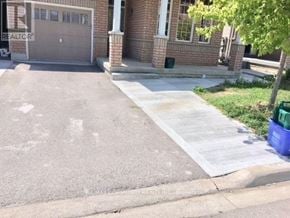 Markham (Box Grove) apartment for rent - A house with a grey garage door and a brown brick wall.