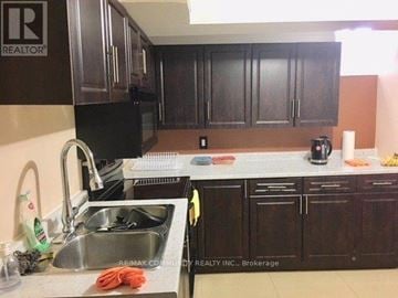 Markham (Box Grove) apartment for rent - A kitchen with dark brown cabinets and a sink.