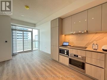 Vaughan (Vaughan Corporate Centre) condo for rent - A modern kitchen with wooden cabinets and stainless steel appliances.