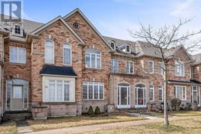 Markham (Cornell) townhouse for rent - A large brick house with a tree in front.