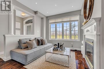 Markham (Cornell) townhouse for rent - A living room with a grey couch and a fireplace.