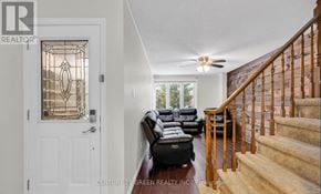 Hamilton (Stoney Creek) apartment for rent - A living room with a staircase leading to the upper floor.