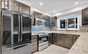 Hamilton (Stoney Creek) apartment for rent - A modern kitchen with stainless steel appliances and a marble countertop.