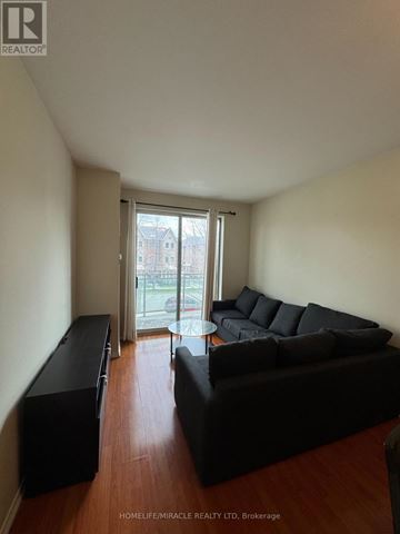 Toronto (Malvern) condo for rent - A living room with a black couch and a television.