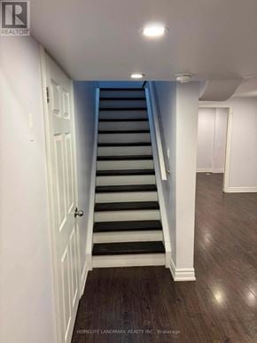 Whitby (Taunton North) townhouse for rent - A staircase with a white door on the left and a light on the ceiling.