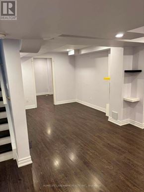 Whitby (Taunton North) townhouse for rent - A room with wooden flooring and white walls.