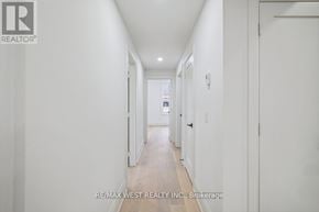 Toronto (Dovercourt-Wallace Emerson-Junction) apartment for rent - A long white hallway with a door on the right.
