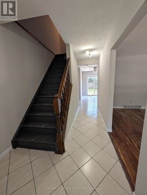 London South (South X) apartment for rent - A hallway with a staircase and a door at the end.