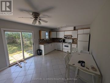 London South (South X) apartment for rent - A kitchen with white cabinets and a ceiling fan.