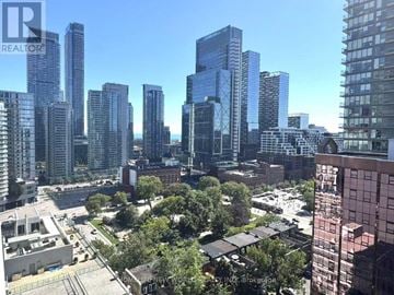 Toronto (Waterfront Communities) house for rent - A cityscape with tall buildings and a clear sky.