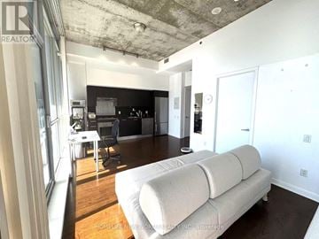 Toronto (Waterfront Communities) house for rent - A living room with a white couch and a television.