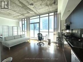 Toronto (Waterfront Communities) house for rent - A modern kitchen with a dining area and a large window.