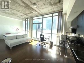 Toronto (Waterfront Communities) house for rent - A well-lit, modern kitchen and living room with a view of the city.