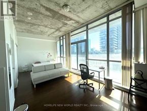 Toronto (Waterfront Communities) house for rent - A sunny day in a modern living room with a view of the city.