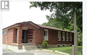 Barrie (Codrington) apartment for rent - A brick house with a black door and windows.