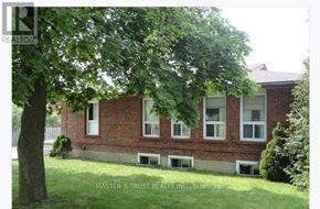 Barrie (Codrington) apartment for rent - A brick house with a tree in front of it.