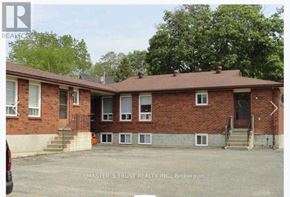 Barrie (Codrington) apartment for rent - A brick building with a car parked in front of it.