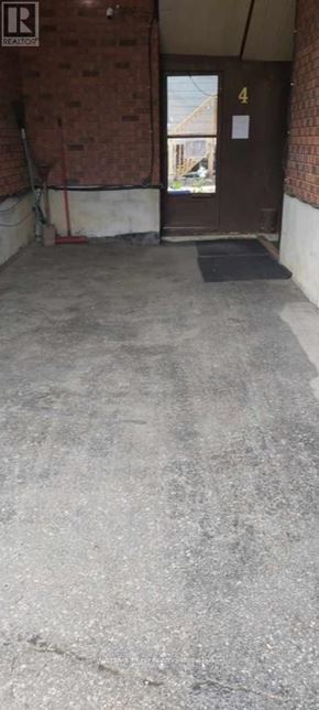 Barrie (Codrington) apartment for rent - A door with a number 4 on it is in a room with a concrete floor.