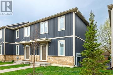 St. Catharines (Oakdale) townhouse for rent - A modern house with a blue exterior and a brick base is shown.